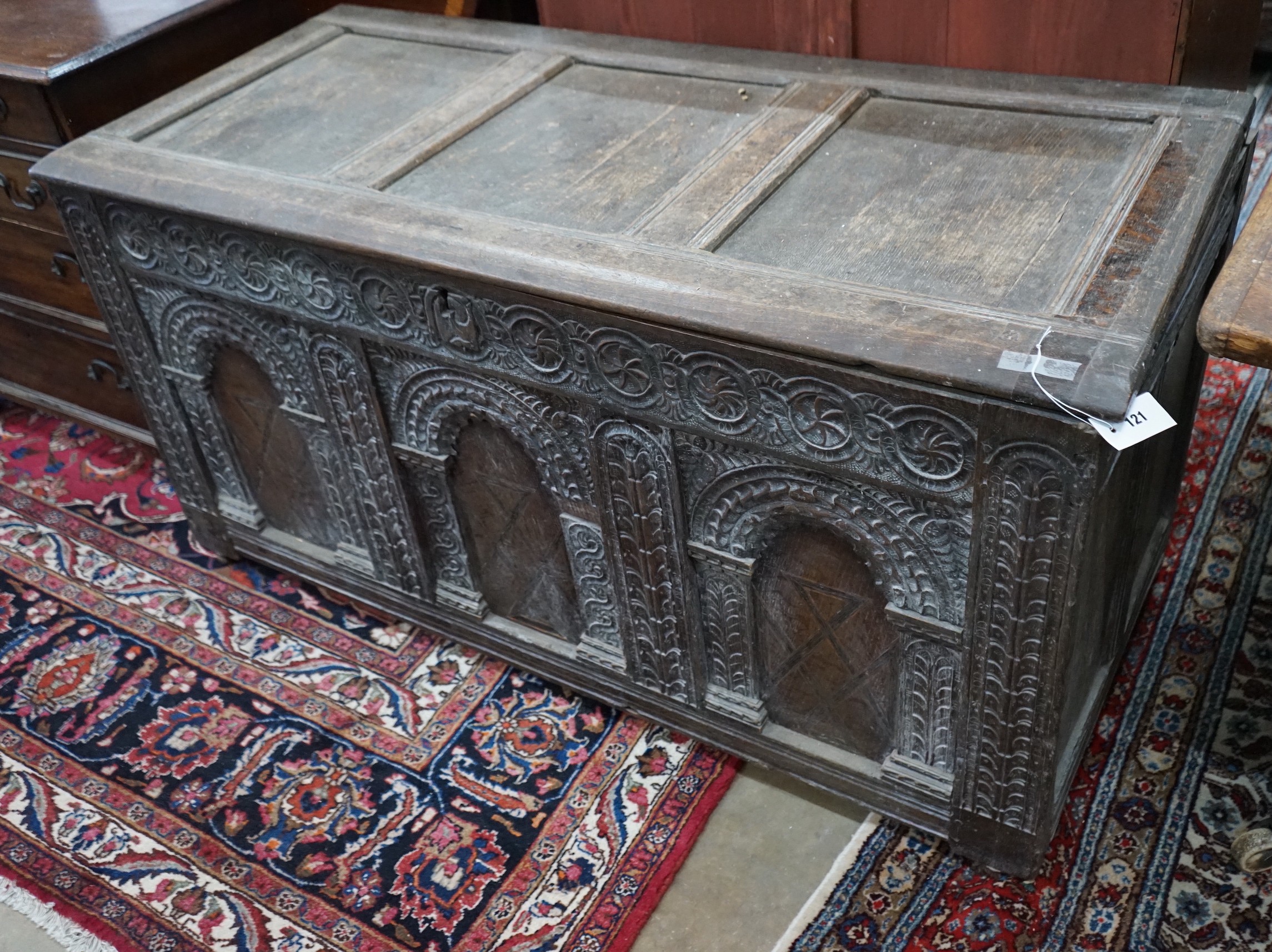 An 18th century carved oak coffer, length 134cm, depth 60cm, height 69cm